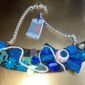 Statement necklace.  Blue glitter eyeball, bow, flower, skull, rhinestone sequin